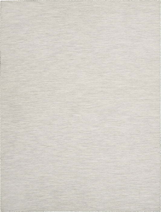 Light gray woven area rug with subtle striped texture and short fringe along edges.