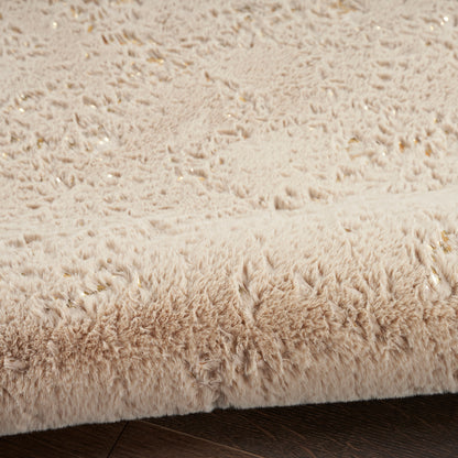 Beige shag rug with dense, fluffy pile on dark wood floor; cozy modern living room accent.