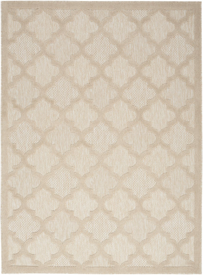 Beige woven area rug featuring a cream and tan quatrefoil lattice pattern.