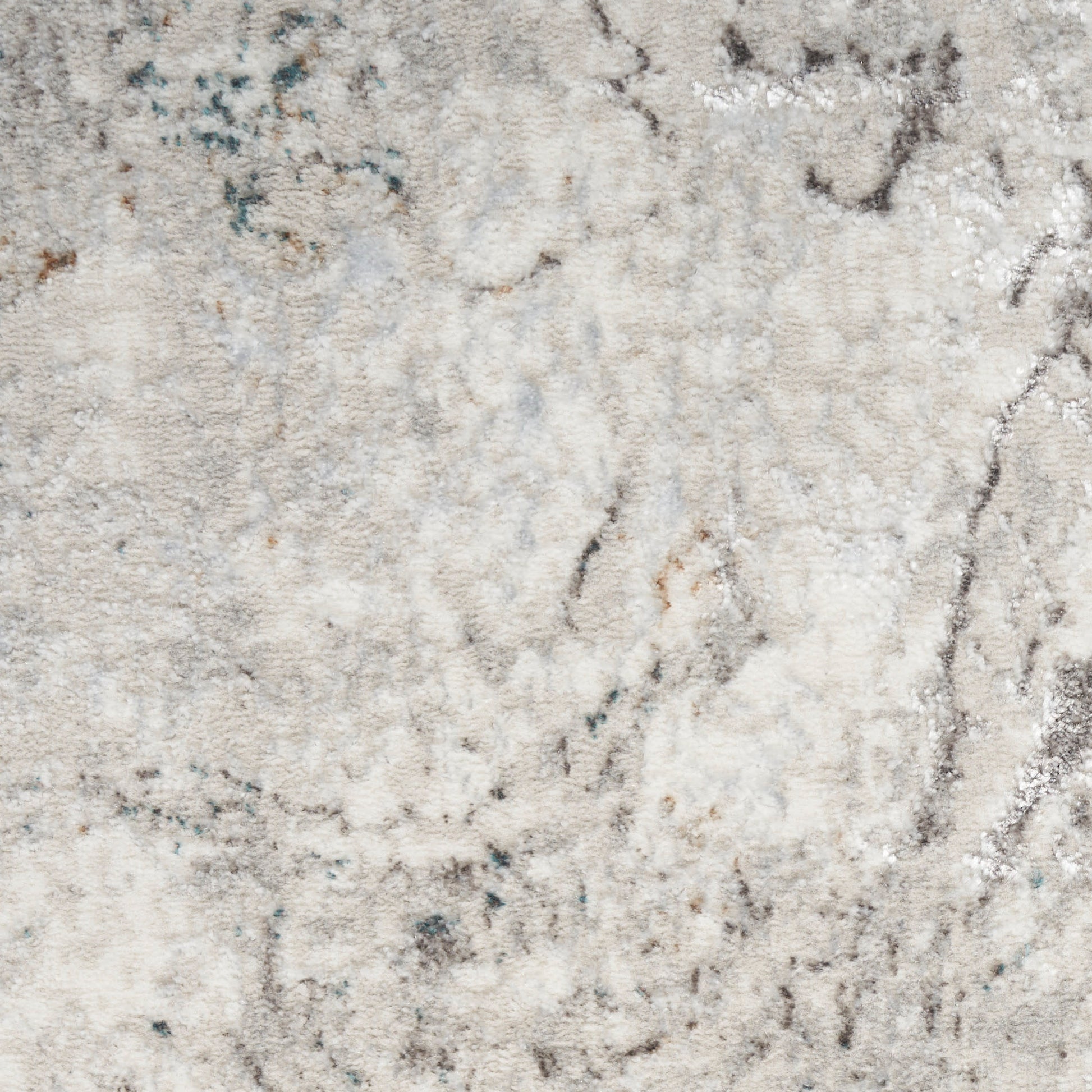 Cream-beige abstract area rug with soft gray-blue marbling; plush pile, modern cozy decor.