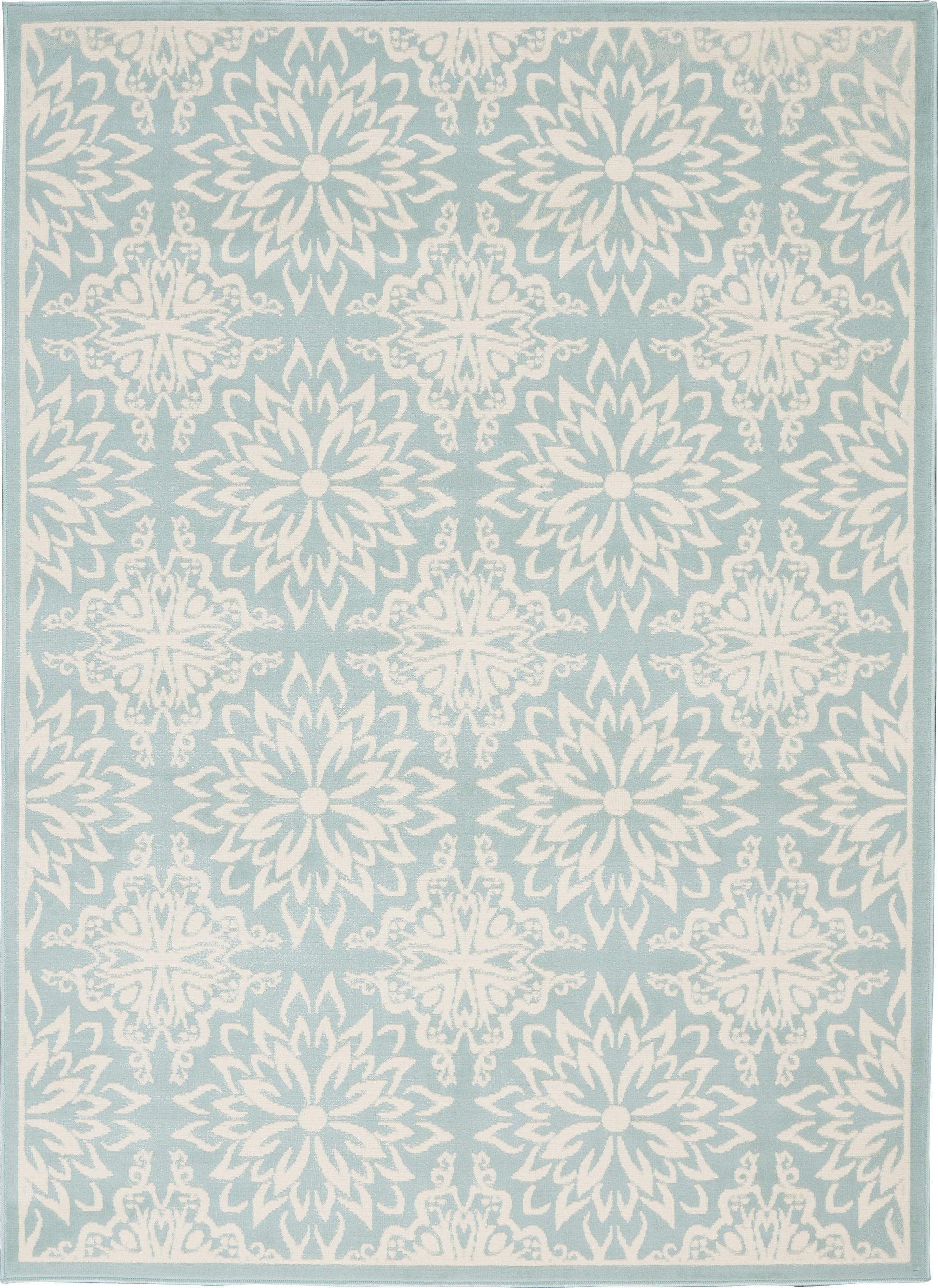 Light blue area rug with repeating white floral medallions and a pale border.