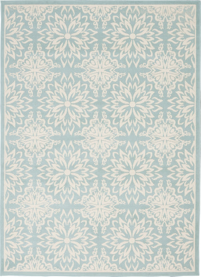 Light blue area rug with repeating white floral medallions and a pale border.