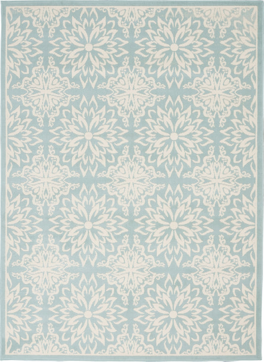 Light blue area rug with repeating white floral medallions and a pale border.