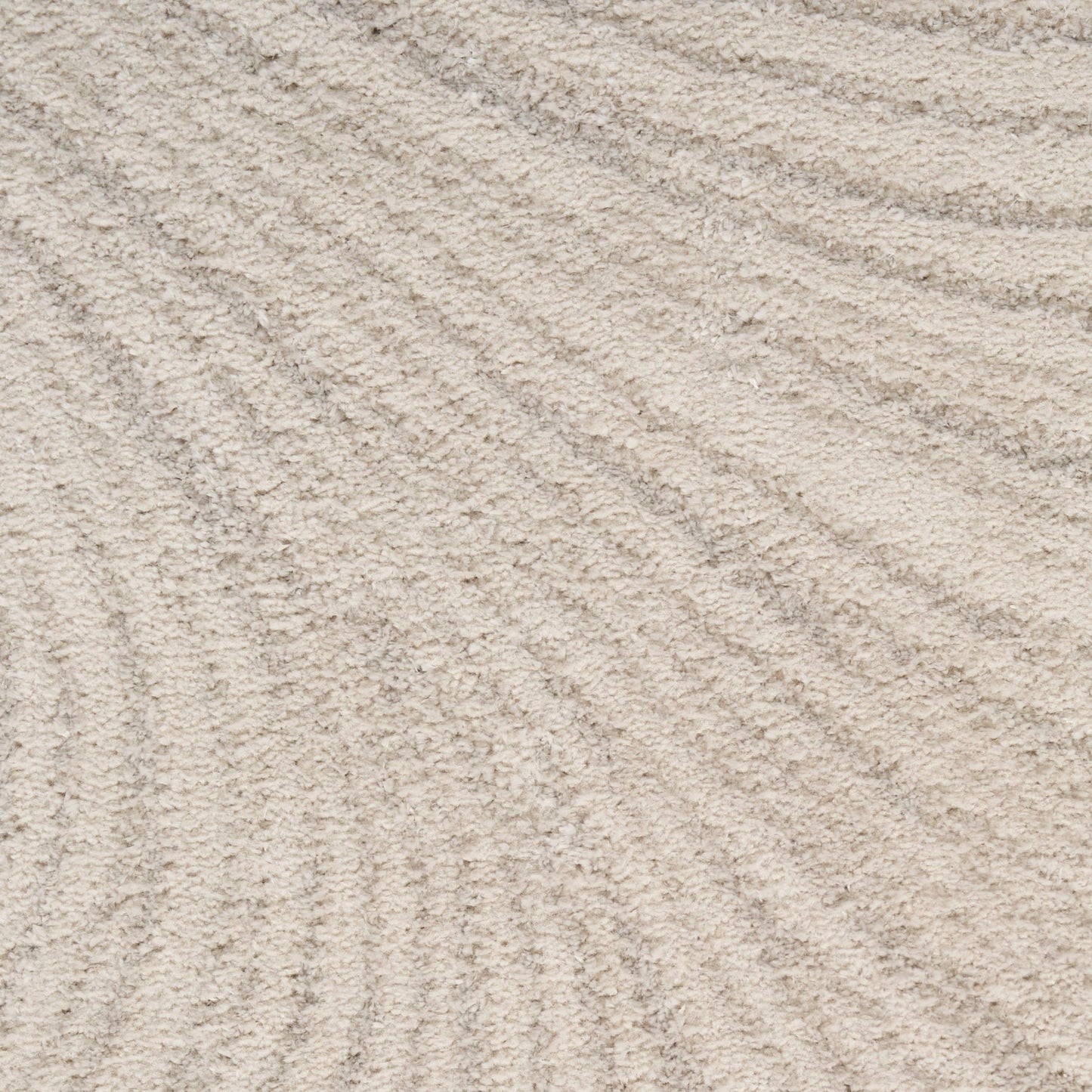 Close-up of beige woven rug fibers with a subtle texture and fine pile.