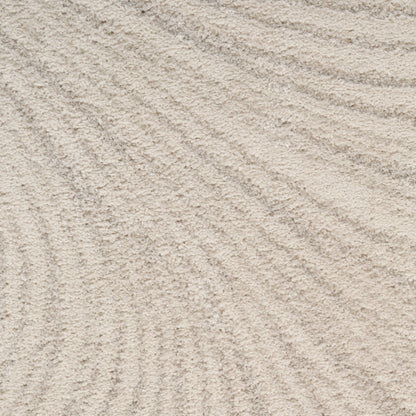 Close-up of beige woven rug fibers with a subtle texture and fine pile.