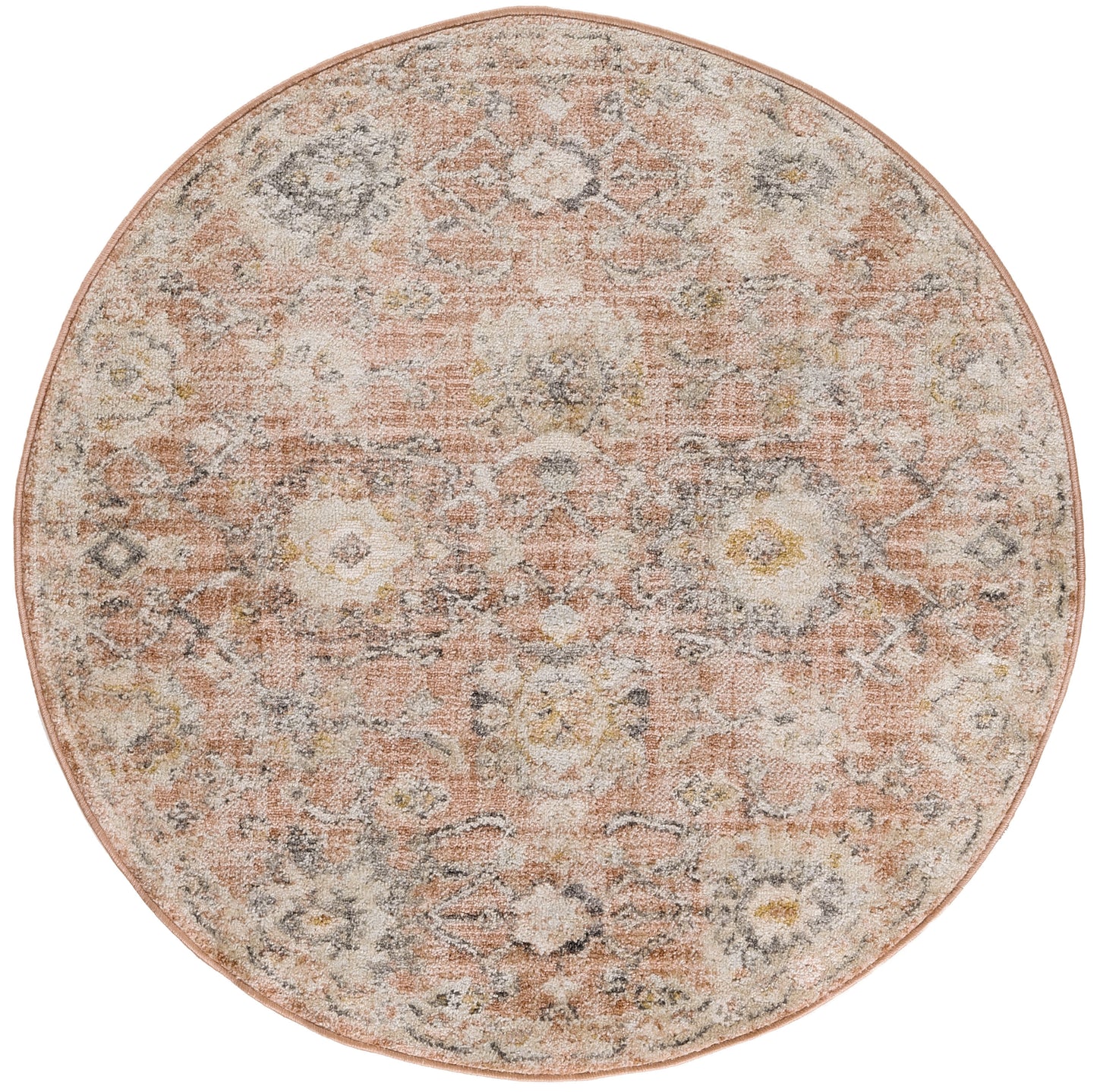 Round vintage-style rug in peach and ivory with a faded floral medallion pattern.