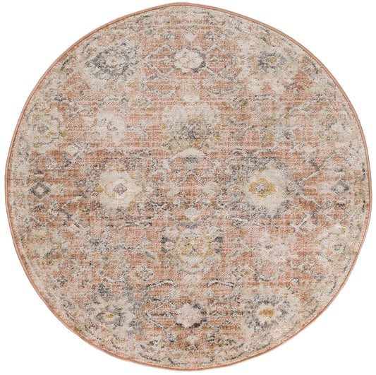 Round vintage-style rug in peach and ivory with a faded floral medallion pattern.