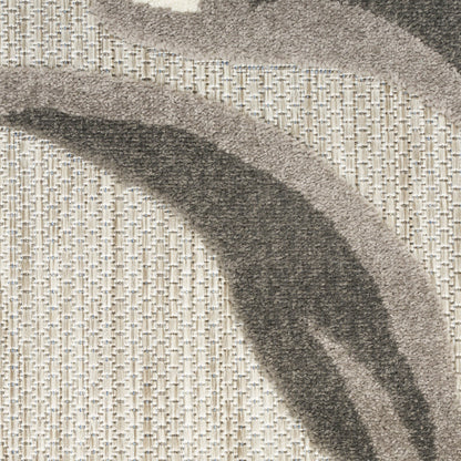Abstract curved-dark gray stripes on a light beige woven rug; textured surface.