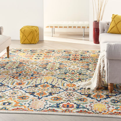 Colorful oriental-style area rug with blue, orange, and yellow floral medallions on cream; living room scene.
