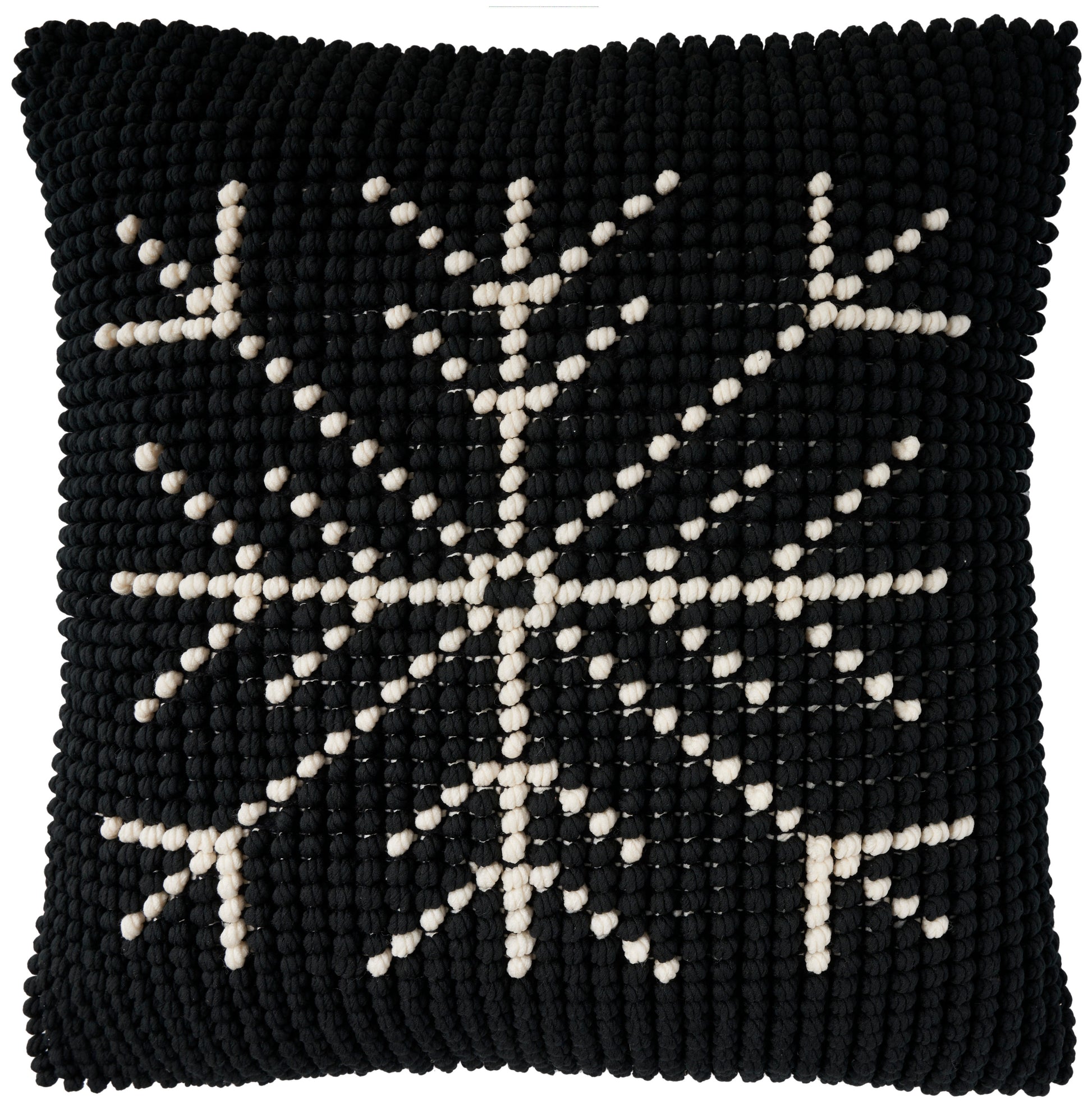 Black square knitted throw pillow with ivory snowflake motif and chunky textured surface, 20 x 20 inches.