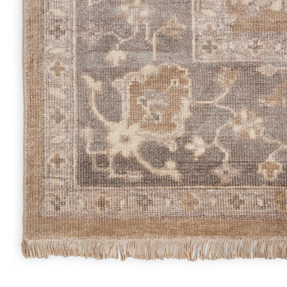 Beige and gray woven rug with floral arabesque pattern and fringe border; Persian-inspired, rectangular.