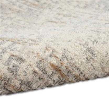 Cream beige shag area rug with plush high-pile texture and subtle gray-tan mottling along the edge.