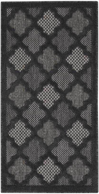 Charcoal rug with alternating light gray diamond shapes in a lattice pattern and textured inserts; dark border.