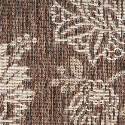 Brown and cream jacquard woven rug with floral vine motif; textured rug.