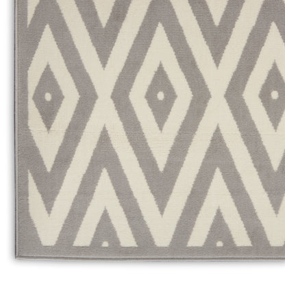 Gray and cream geometric rug with diamond motifs, soft woven pile, contemporary tribal style.