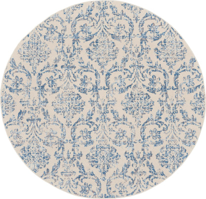 Round beige area rug with blue damask floral pattern and ornamental scrollwork.
