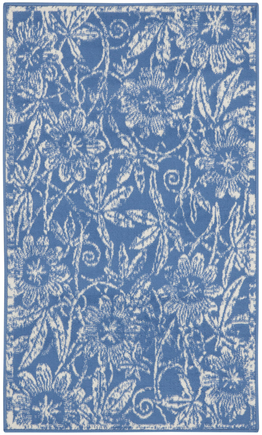 Blue rug with white floral damask pattern and decorative border; rectangular home decor.