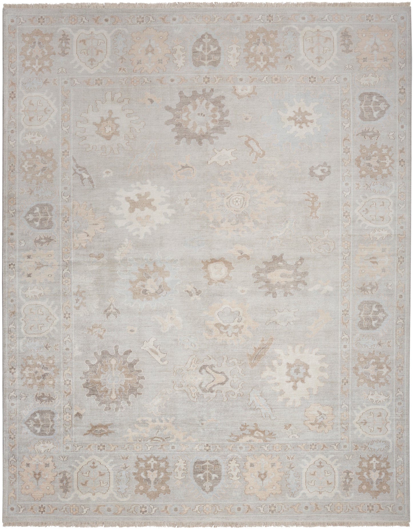 Distressed pale blue oriental area rug with beige floral medallions and ornate border; soft, low-contrast vintage look.