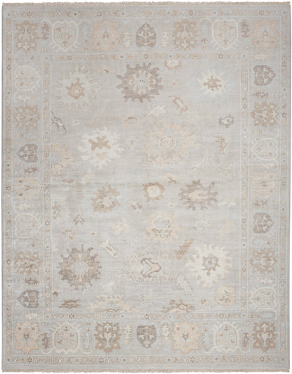 Distressed pale blue oriental area rug with beige floral medallions and ornate border; soft, low-contrast vintage look.