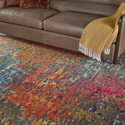 Brown leather sofa with mustard-yellow throw blanket draped over arm; multicolor abstract rug beneath.