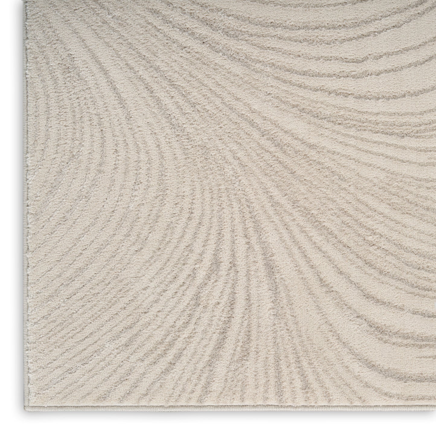 Beige textured rug with soft pile and subtle curved wave pattern.
