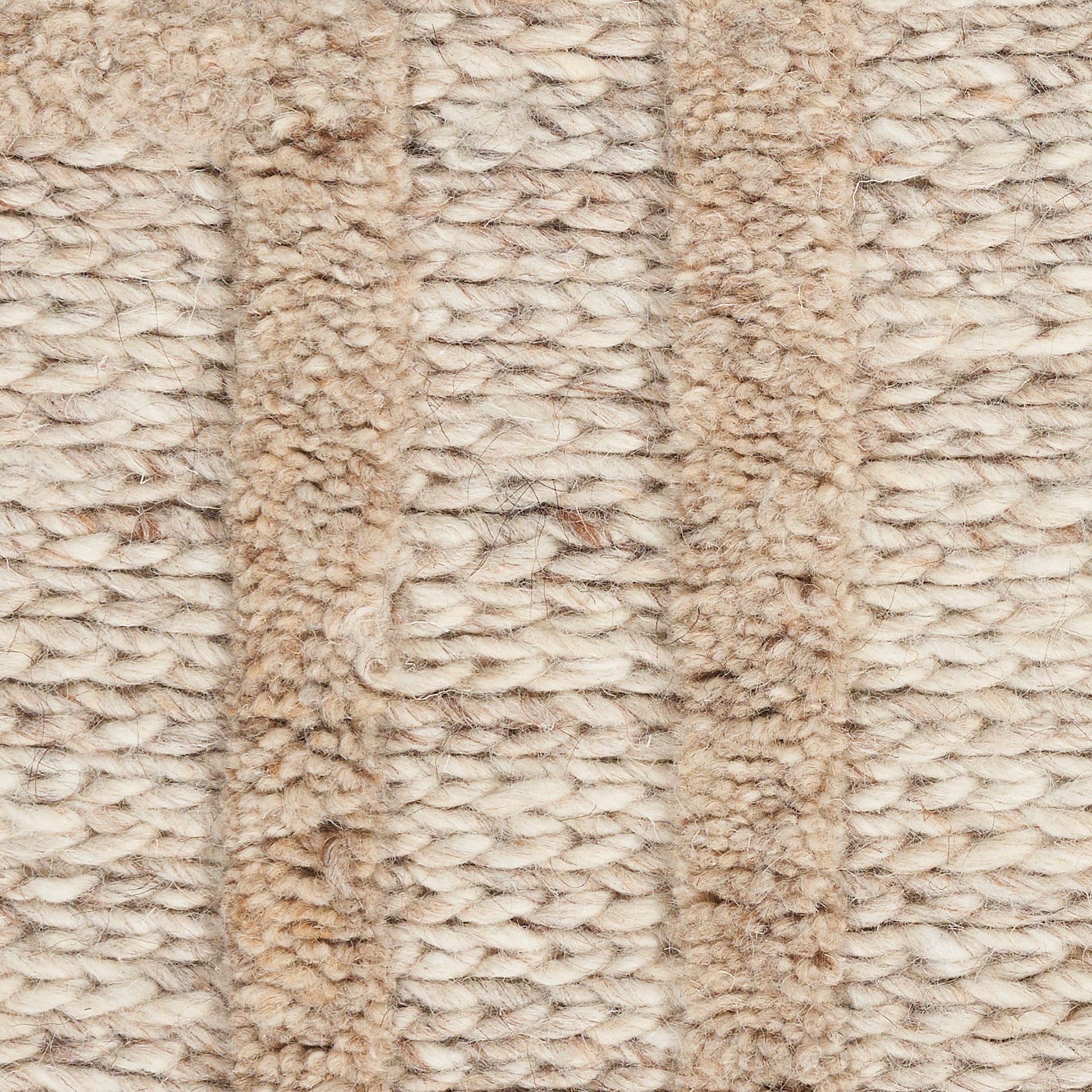Close-up of beige boucle rug with plush looped pile in cream and tan hues, cozy living-room decor.