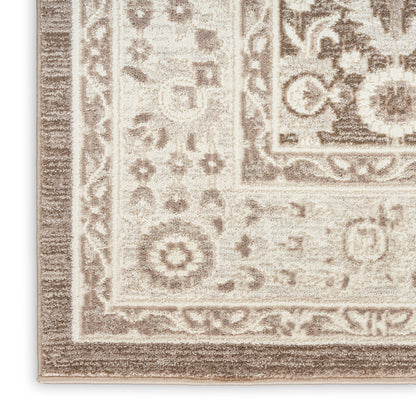 Beige-taupe oriental rug corner with decorative floral border and medallion motif; woven, soft textured pile.