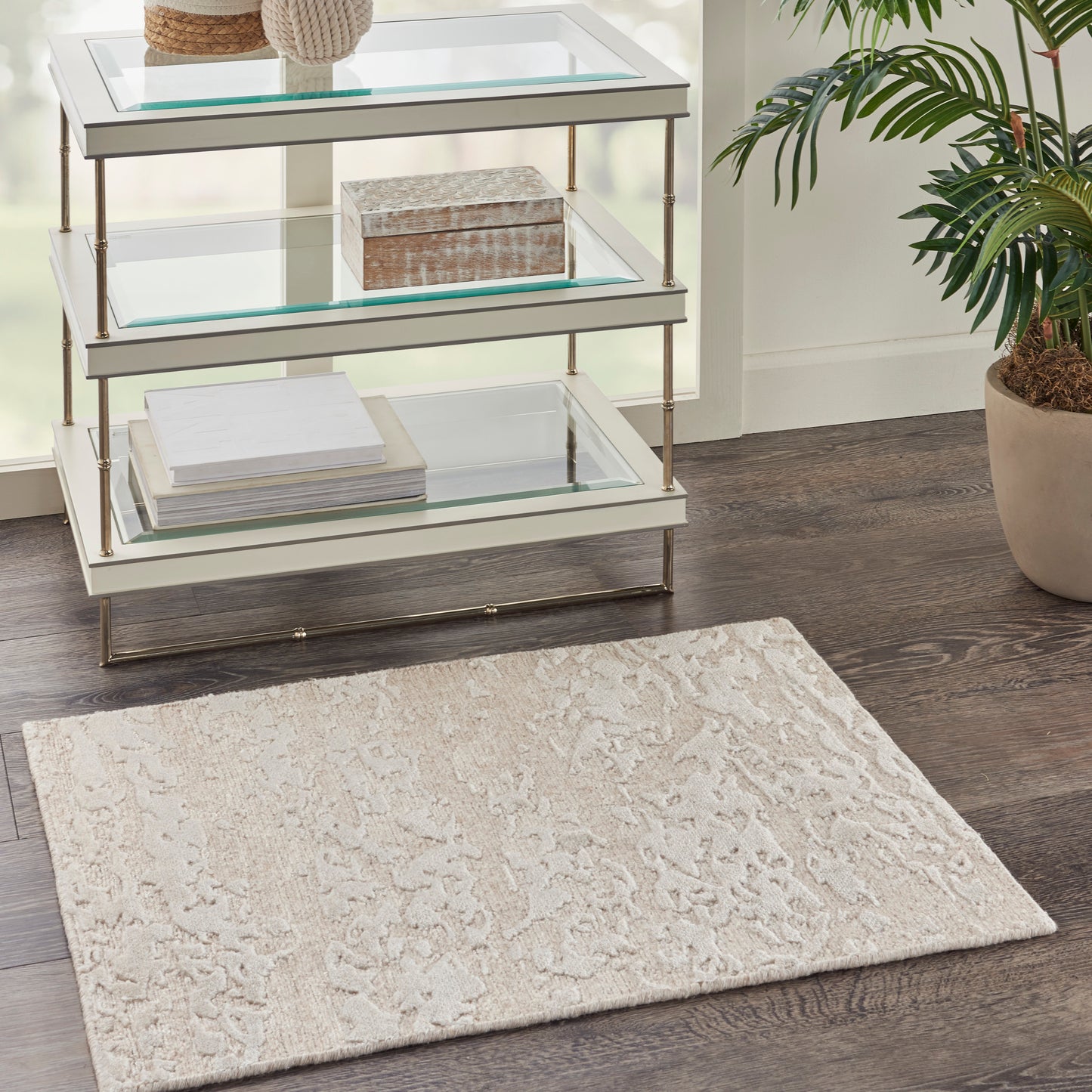 Modern 2' x 3' rug on dark wood floor.