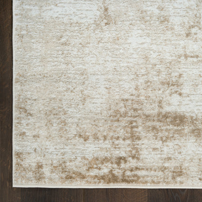 Beige distressed-pattern area rug on dark wood floor; rectangular, soft neutral tones ideal for contemporary living spaces.