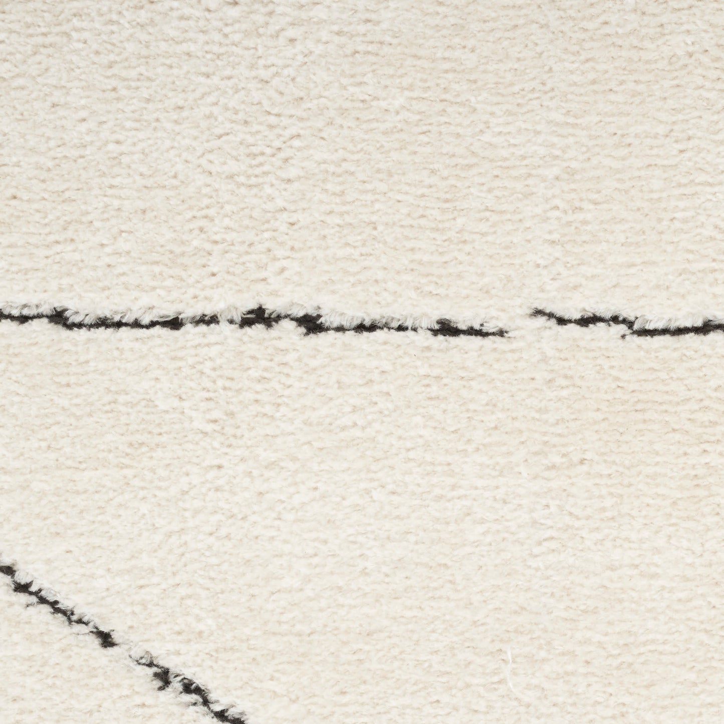 Cream shag rug with black linear lines in a minimal modern geometric pattern.