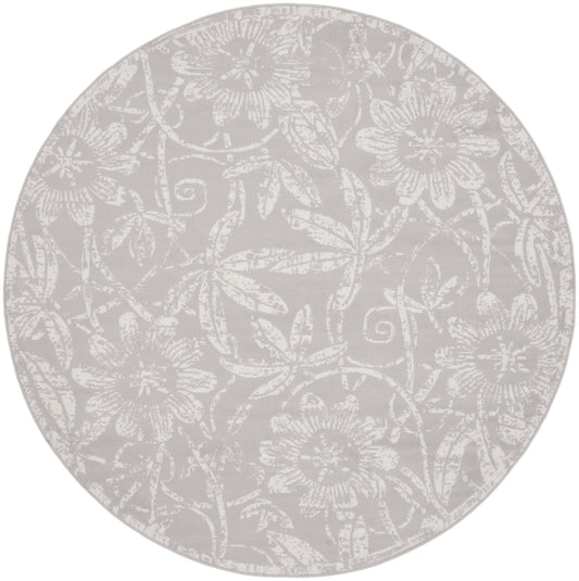 Round grey rug with a subtle white floral damask pattern.