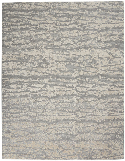 Rectangular gray and cream abstract-pattern area rug with a textured, marled look for modern living spaces.