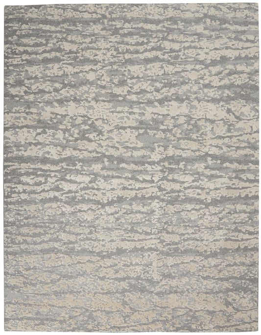 Rectangular gray and cream abstract-pattern area rug with a textured, marled look for modern living spaces.