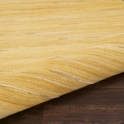 Mustard yellow woven rug with subtle white stripes, draped over a dark wood surface.
