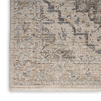 Traditional oriental style area rug in beige, ivory & pale blue-gray with ornate floral border & fringe.