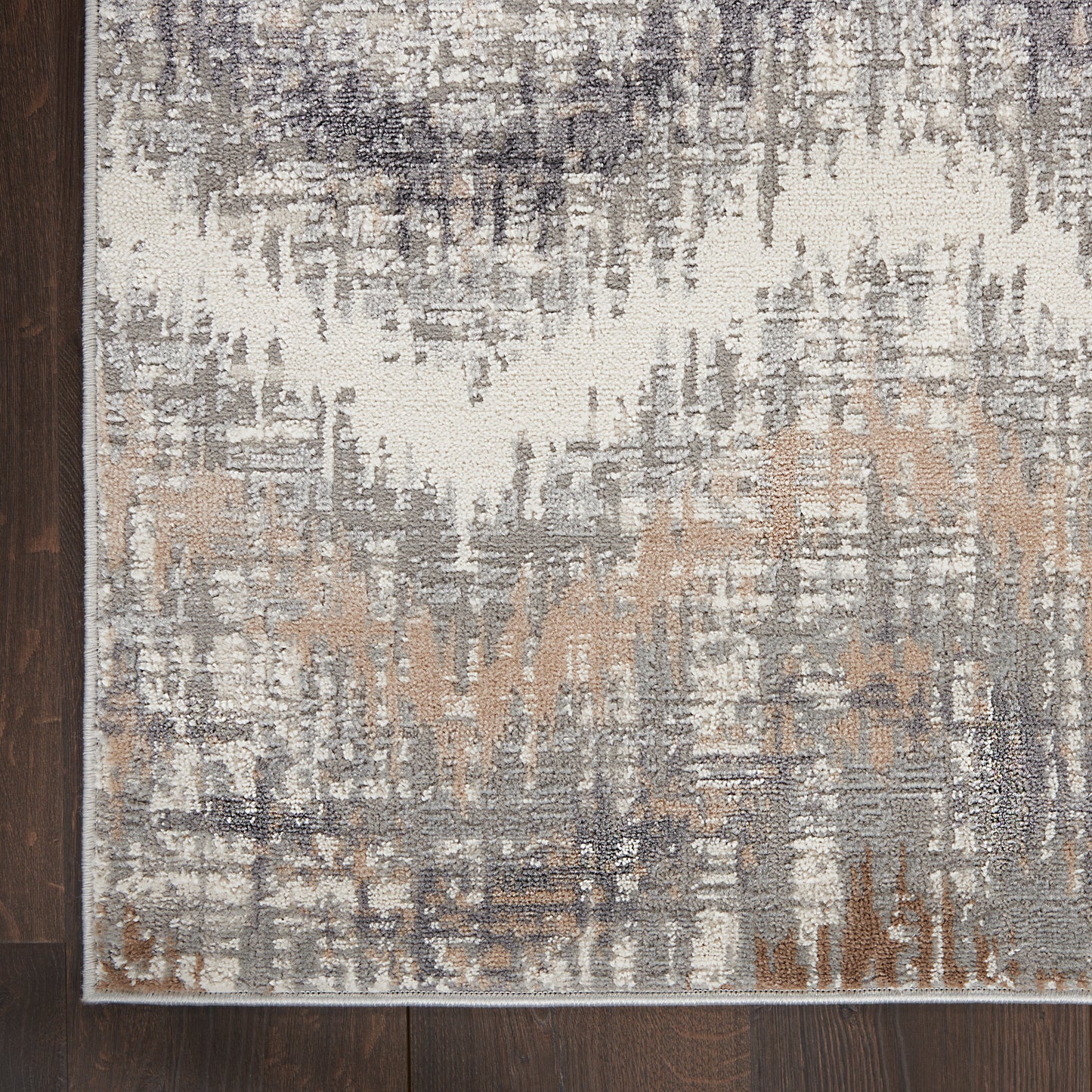 Rectangular abstract area rug in ivory, gray, taupe and tan with a distressed pattern; modern neutral decor.