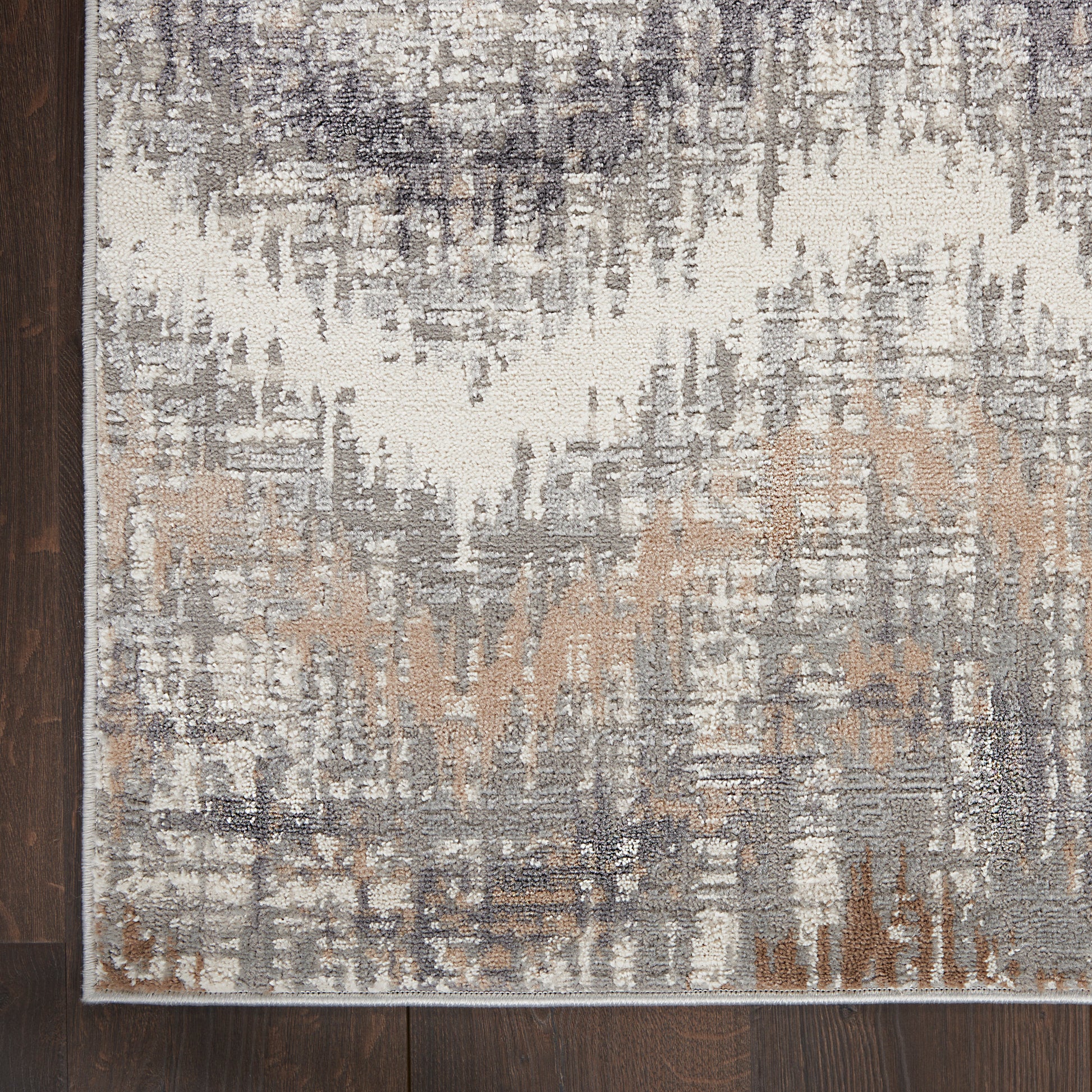 Rectangular abstract area rug in ivory, gray, taupe and tan with a distressed pattern; modern neutral decor.