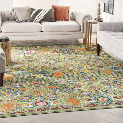 Colorful floral area rug with green, orange, blue hues on light wood floor in a cozy living room with beige sofa and pillows