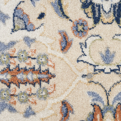Beige oriental area rug with blue and orange floral motifs and intricate vines; plush textured pile.