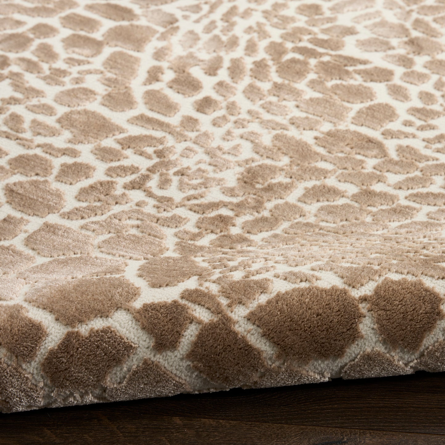 Beige leopard-pattern shag rug with plush pile on cream base, warm tan spots, ideal for living room on dark wood floor
