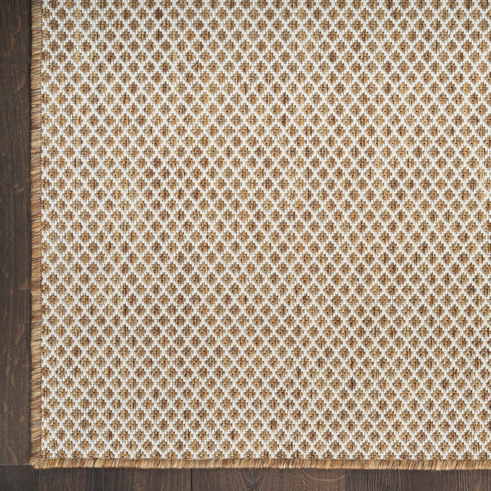 Beige satin rug, rectangular, 10' x 14', with decorative white trim along the edge.
