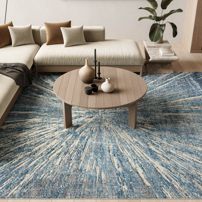 Blue and white sunburst rug in a living room with a beige sectional and a trio of vases.