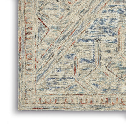 Cream and light blue rug corner with geometric lattice pattern, rust border, textured pile.