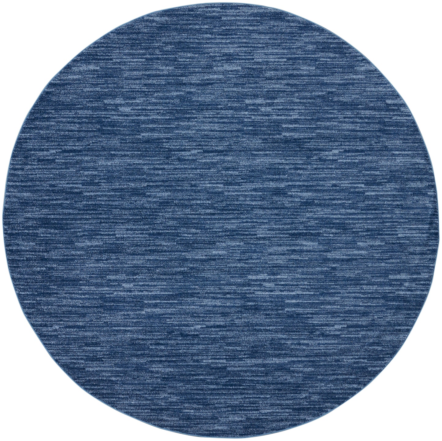 Round blue outdoor rug with a heathered denim texture; soft, casual decor accent.
