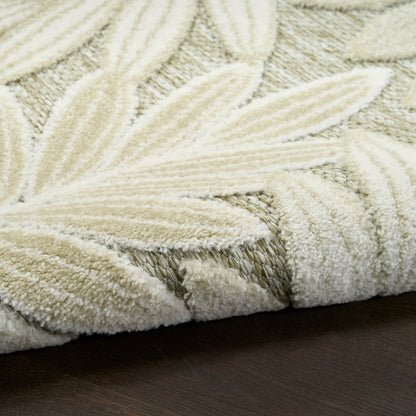 Ivory shag rug with a raised leaf motif and plush texture on a dark wooden floor.