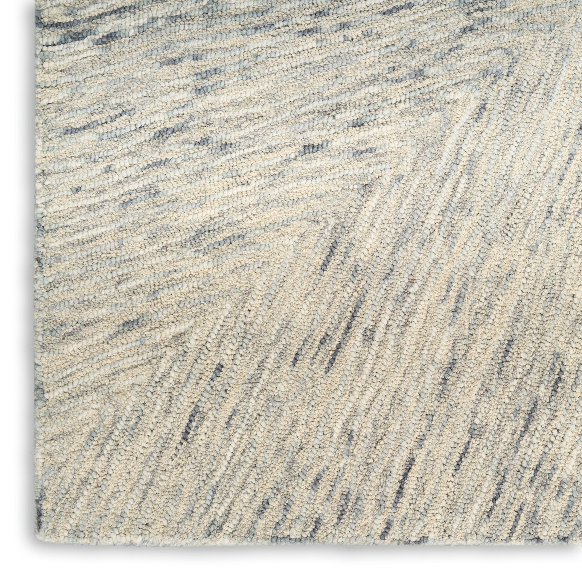 Beige textured rug with soft shag fibers and subtle blue-gray chevron waves, cozy living-room style.