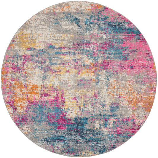 Round abstract area rug with a watercolor-like wash of pink, teal, orange, yellow and blue.