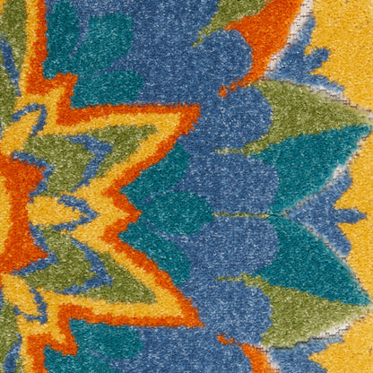 Close-up of a vibrant, abstract rug with jagged orange zigzags and blue, teal, green, and yellow blocks, shaggy pile texture.