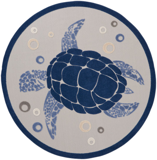 Round rug featuring a navy sea turtle motif on beige background with a dark blue border and light-blue bubbles.
