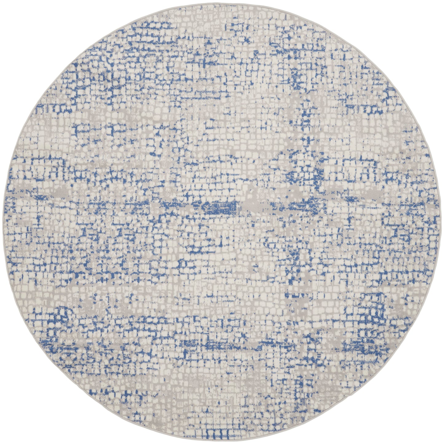 Round beige rug featuring a blue distressed abstract pattern and soft woven texture for a modern, casual look.